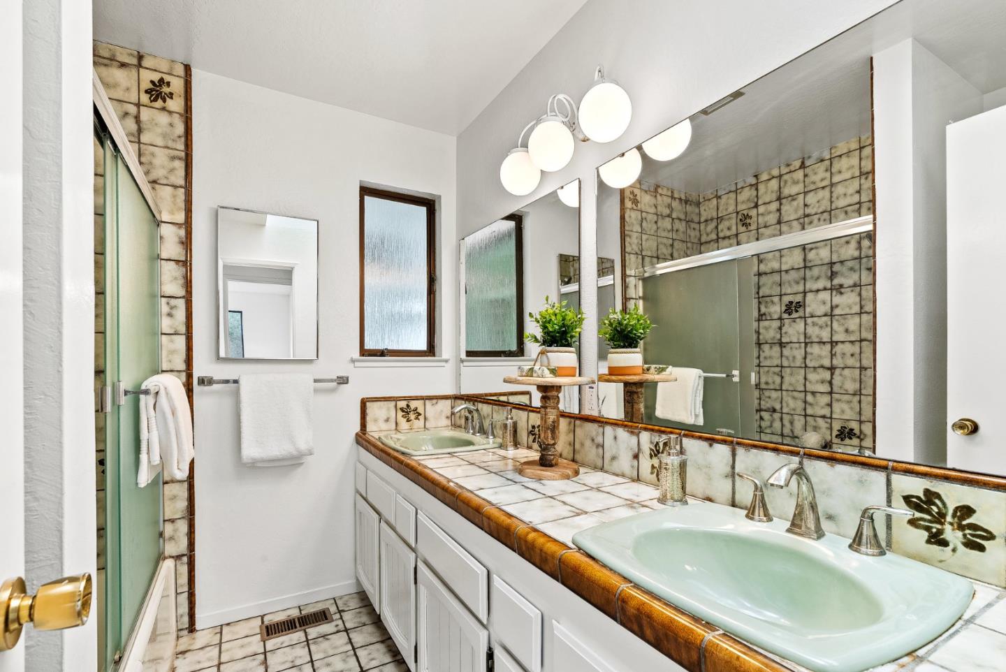 330 Enos Lane Corralitos, CA 95076 - Photo 31 of 73 a bathroom with a double vanity sink and a mirror