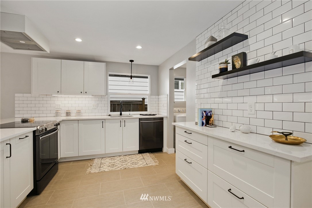 10014 40th Avenue Southwest Seattle, WA 98146 - Photo 12 of 36 a kitchen with granite countertop white cabinets and white appliances