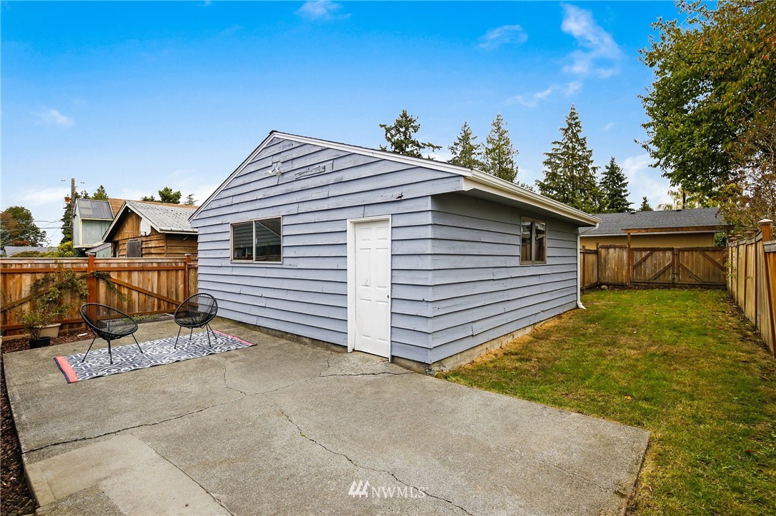 10014 40th Avenue Southwest Seattle, WA 98146 - Photo 17 of 36 a view of a house with a backyard and trees
