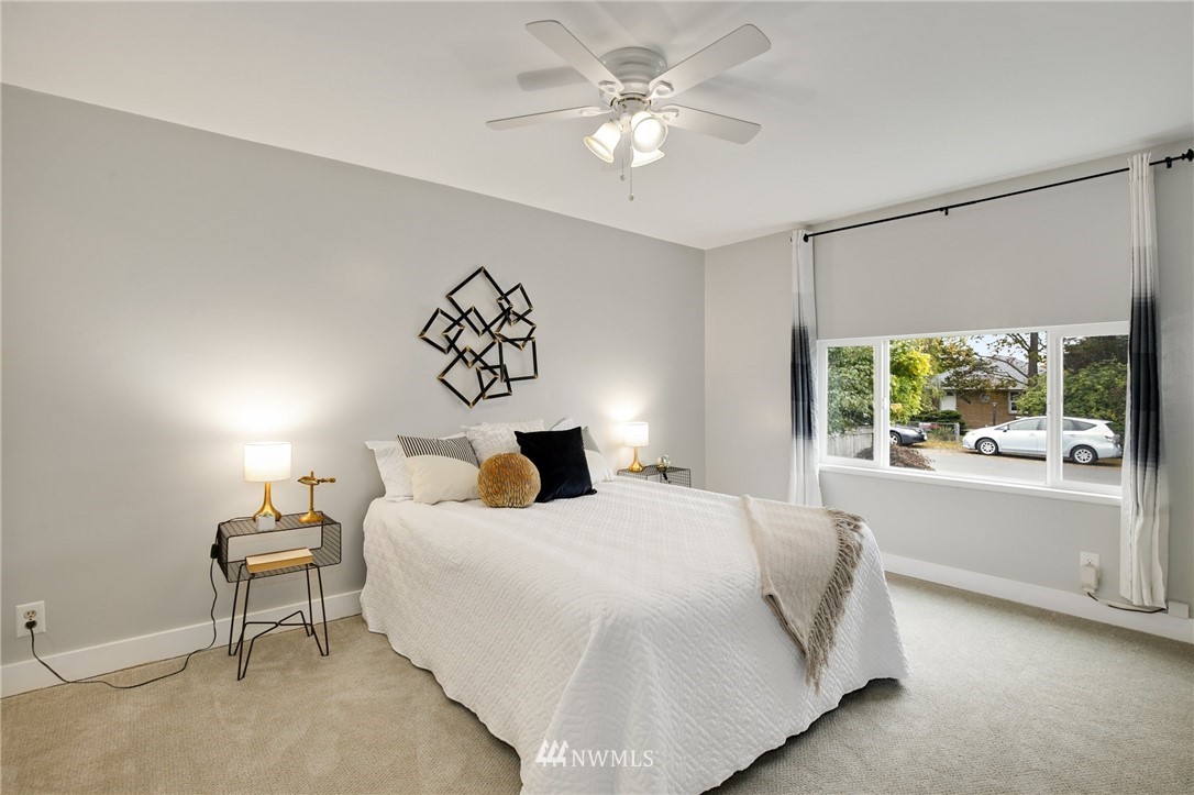 10014 40th Avenue Southwest Seattle, WA 98146 - Photo 21 of 36 a bedroom with a large bed and a window