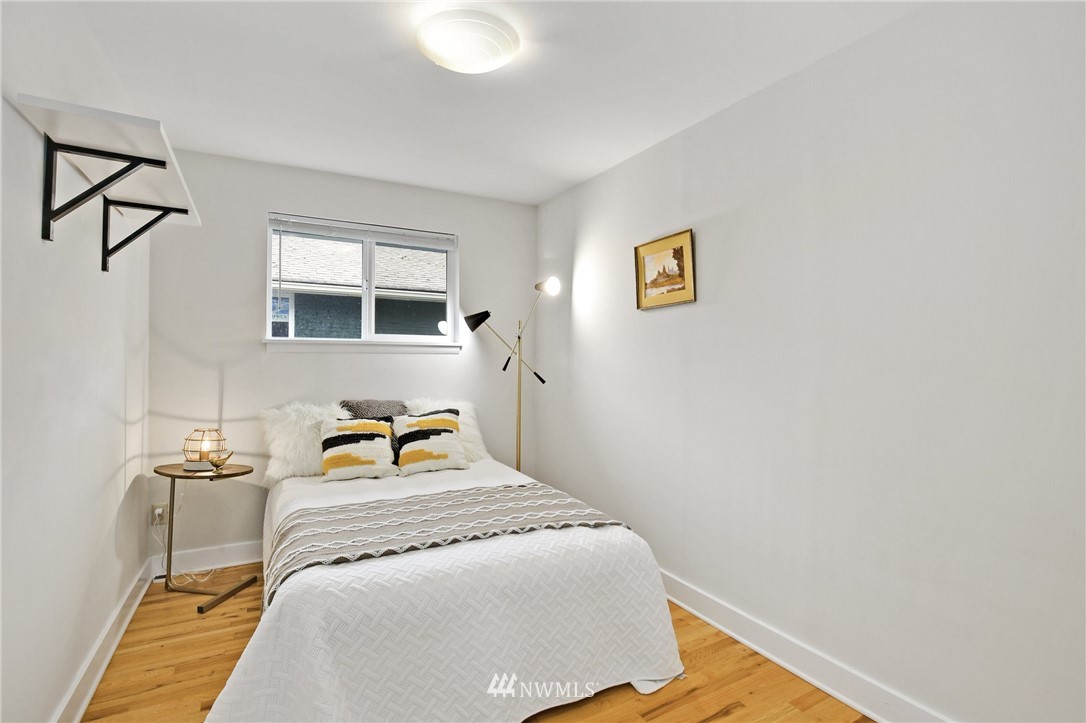 10014 40th Avenue Southwest Seattle, WA 98146 - Photo 24 of 36 a bedroom with a bed next to a window