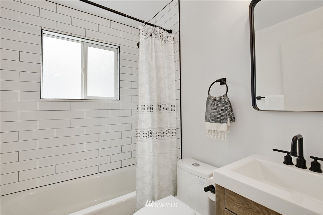 10014 40th Avenue Southwest Seattle, WA 98146 - Photo 26 of 36 a bathroom with a sink a toilet and shower