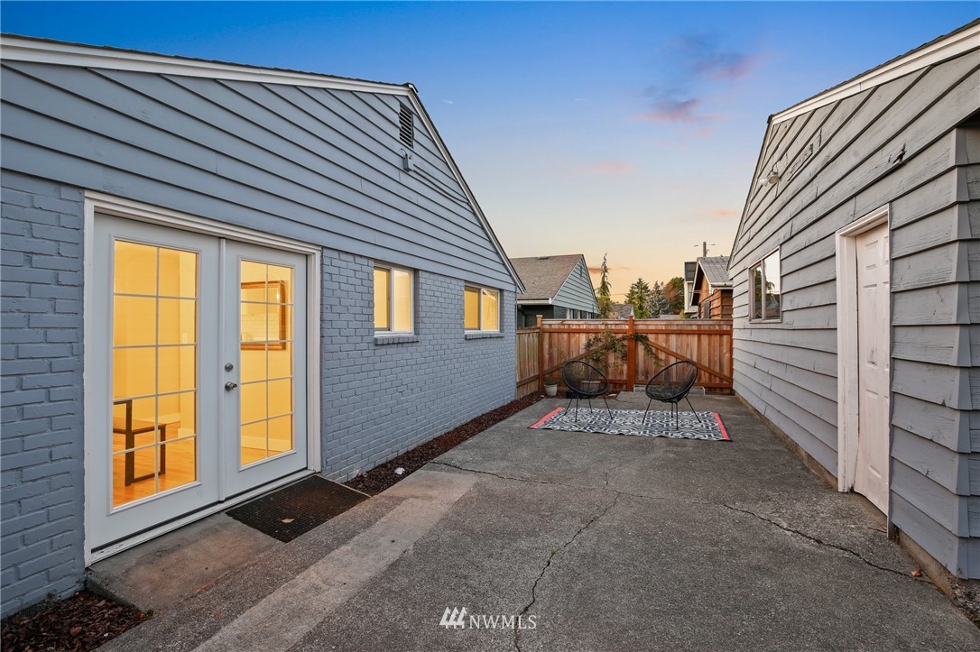 10014 40th Avenue Southwest Seattle, WA 98146 - Photo 30 of 36 a view of a house with wooden floor next to a building