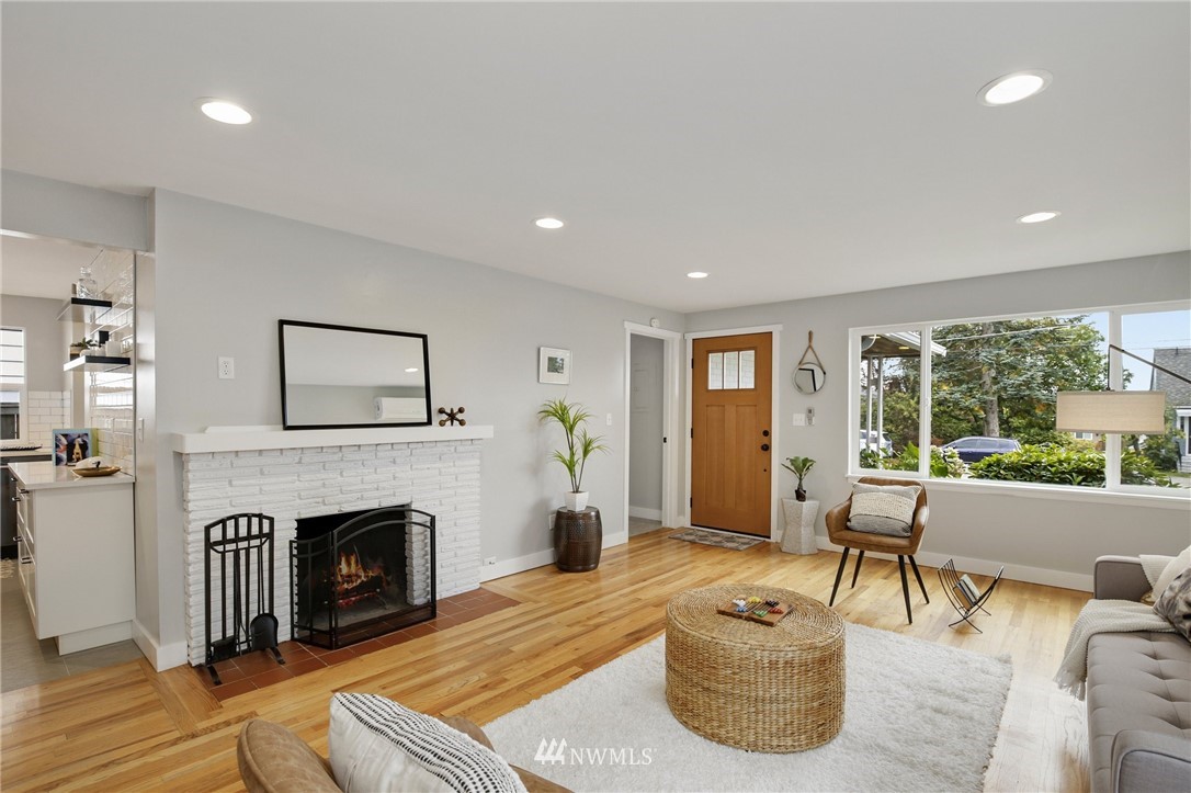 10014 40th Avenue Southwest Seattle, WA 98146 - Photo 4 of 36 a living room with furniture and a fireplace