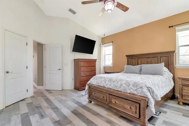 a bedroom with a bed and a flat screen tv