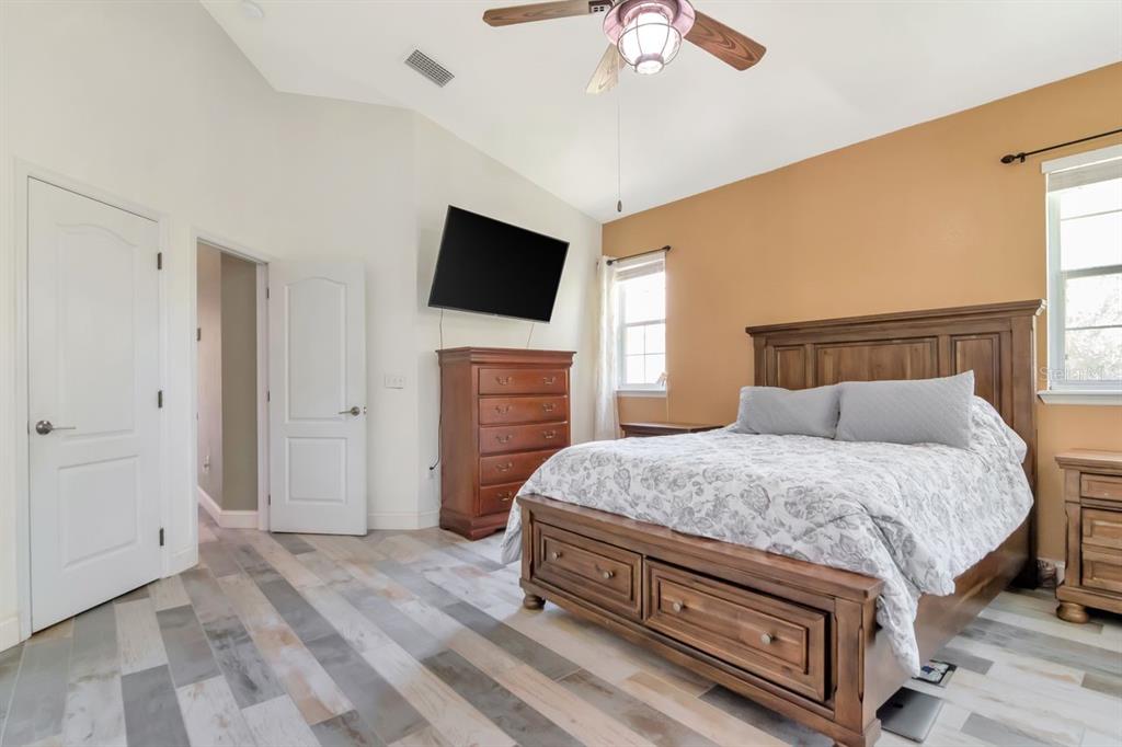 8880 Moonlit Meadows Loop Riverview, FL 33578 - Photo 21 of 43 a bedroom with a bed and a flat screen tv