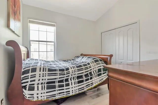 a bedroom with a bed and a painting on the wall