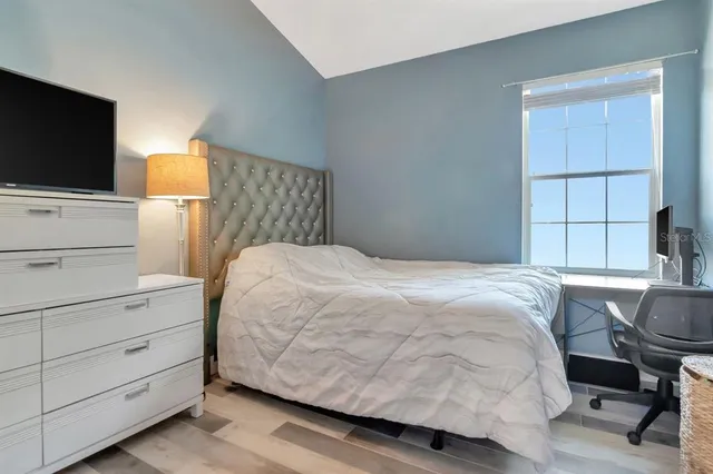 a bedroom with a bed and flat screen tv