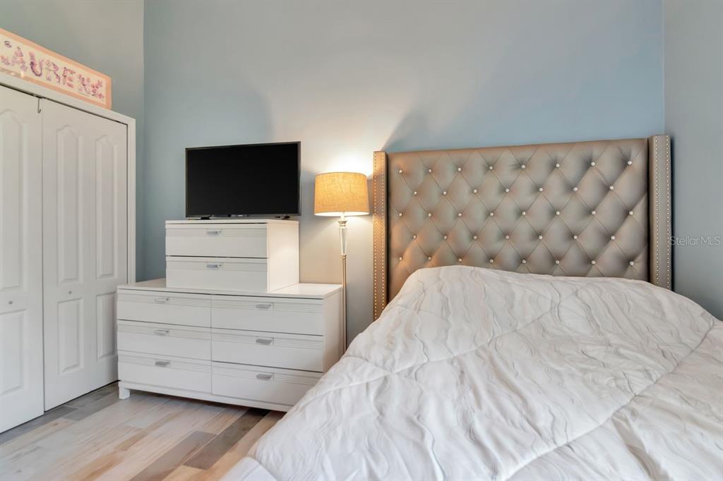 8880 Moonlit Meadows Loop Riverview, FL 33578 - Photo 31 of 43 a bedroom with a bed and flat screen tv