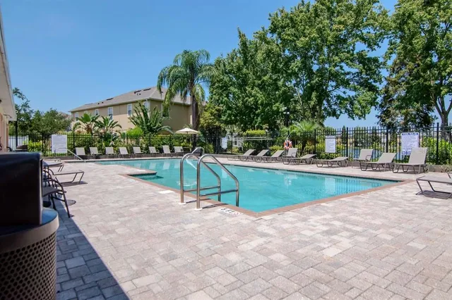 a view of house with swimming pool outdoor seating