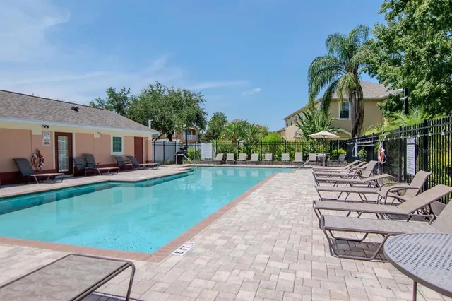 a view of a house with swimming pool and sitting area