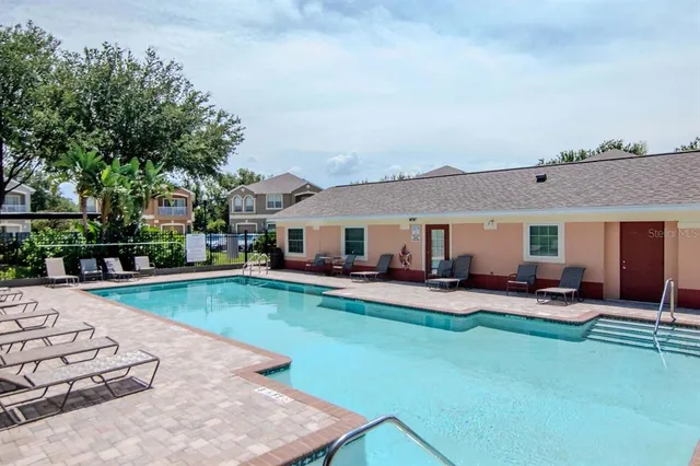 an outdoor view of a garden with swimming pool