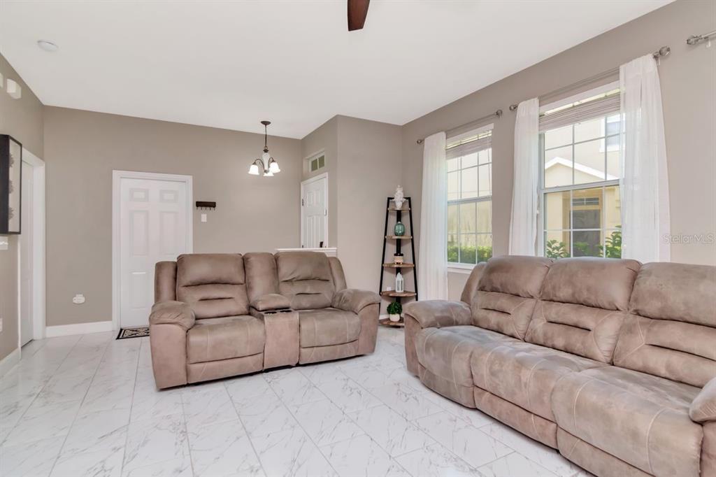 8880 Moonlit Meadows Loop Riverview, FL 33578 - Photo 6 of 43 a living room with furniture and a large window