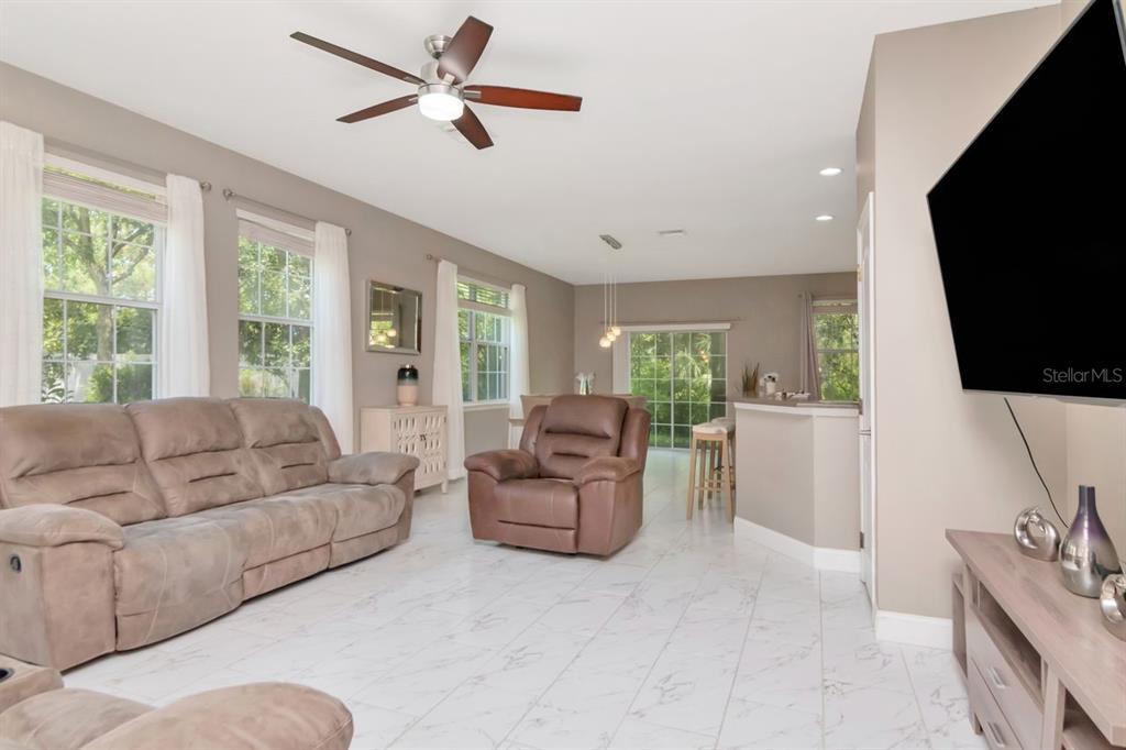 8880 Moonlit Meadows Loop Riverview, FL 33578 - Photo 7 of 43 a living room with furniture a flat screen tv and a large window