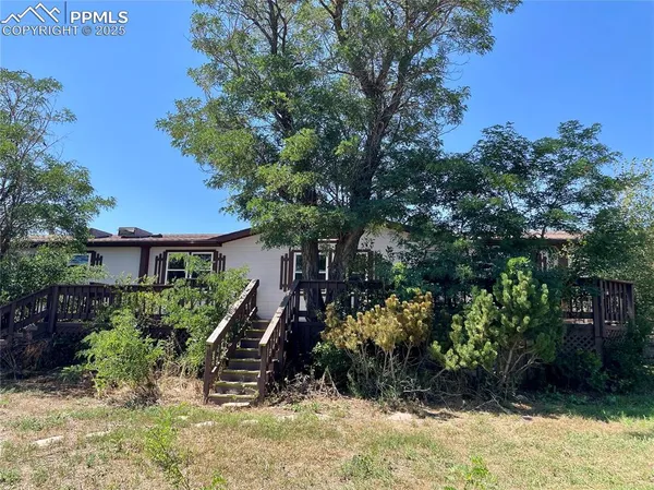 a view of a house with a tree in the background