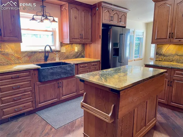 a kitchen with stainless steel appliances granite countertop wooden cabinets a sink and dishwasher