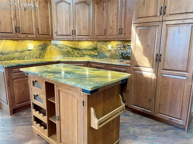 a kitchen with stainless steel appliances granite countertop a refrigerator a sink and a stove