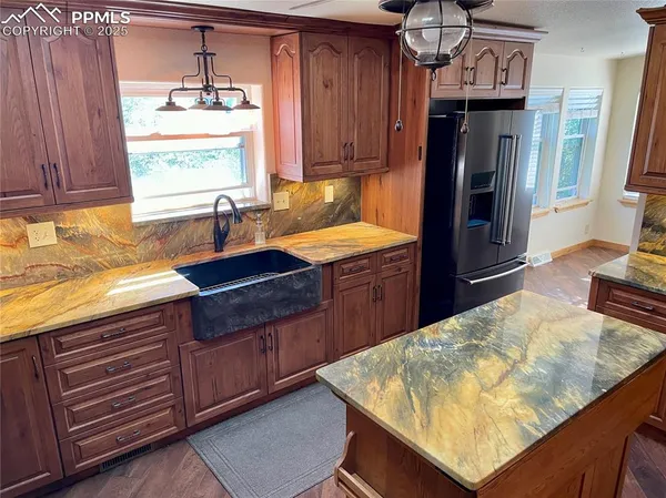 a kitchen with stainless steel appliances wooden cabinets a stove and a refrigerator