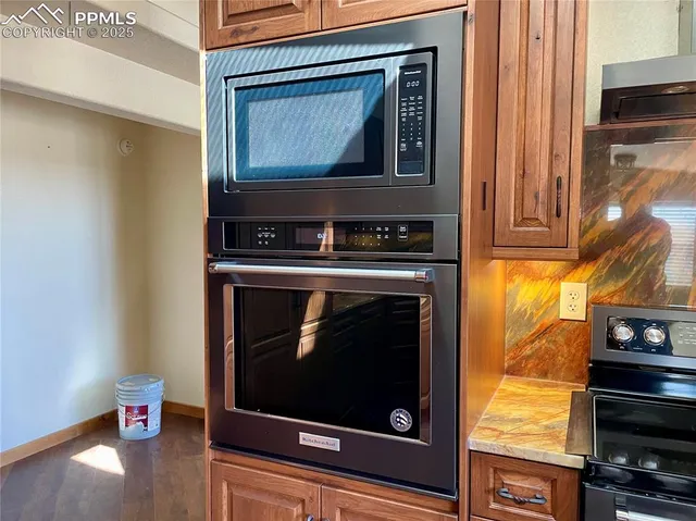 a stove top oven sitting inside of a kitchen