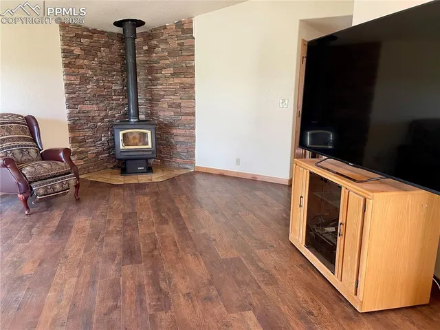 a living room with furniture wooden floor and a flat screen tv