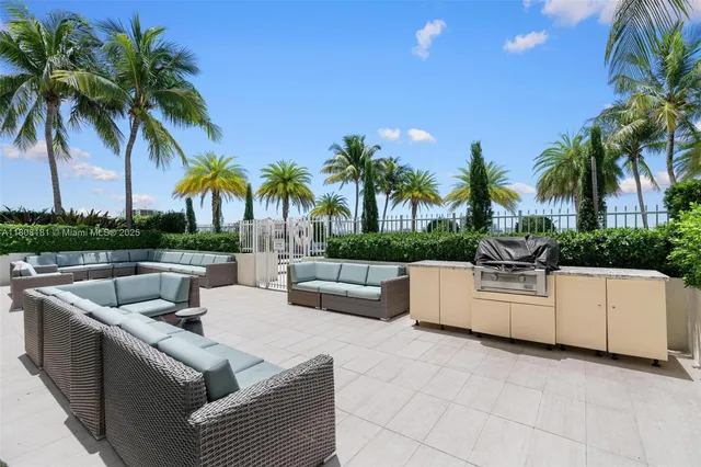 a view of a swimming pool with a couches and a fire pit