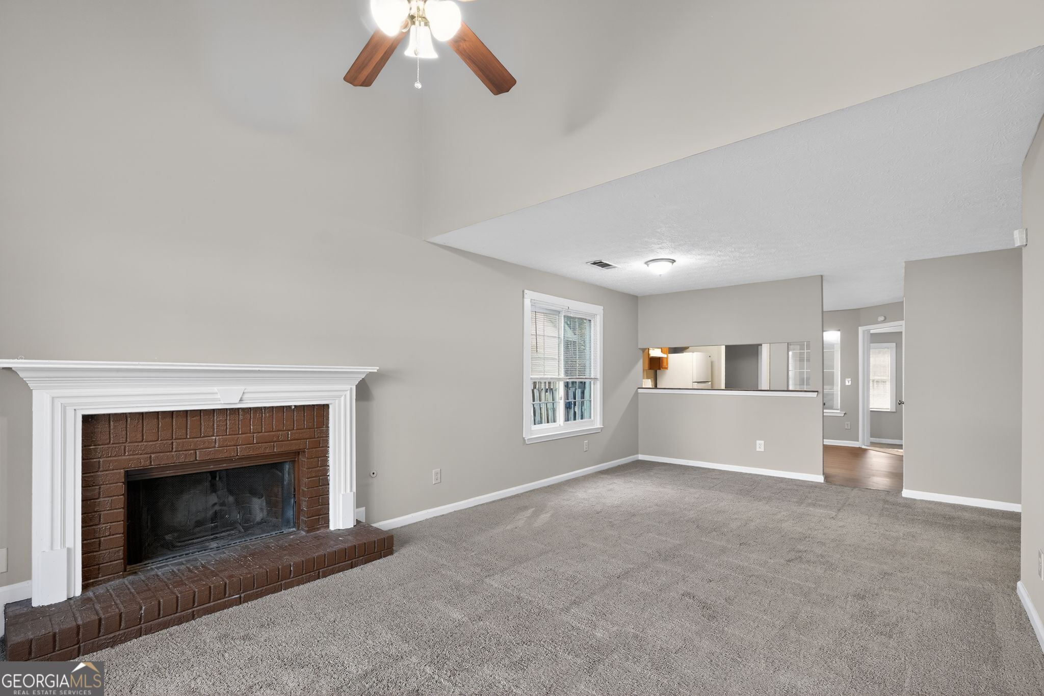 3751 Oakwood Manor Court Decatur, GA 30032 - Photo 11 of 33 a view of a livingroom with a fireplace and chandelier fan
