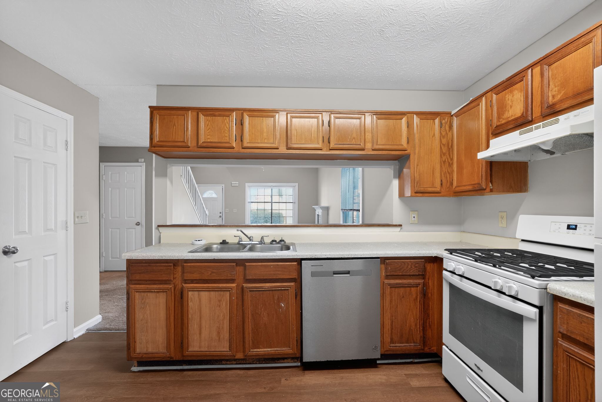 3751 Oakwood Manor Court Decatur, GA 30032 - Photo 18 of 33 a kitchen with stainless steel appliances granite countertop a stove and a sink