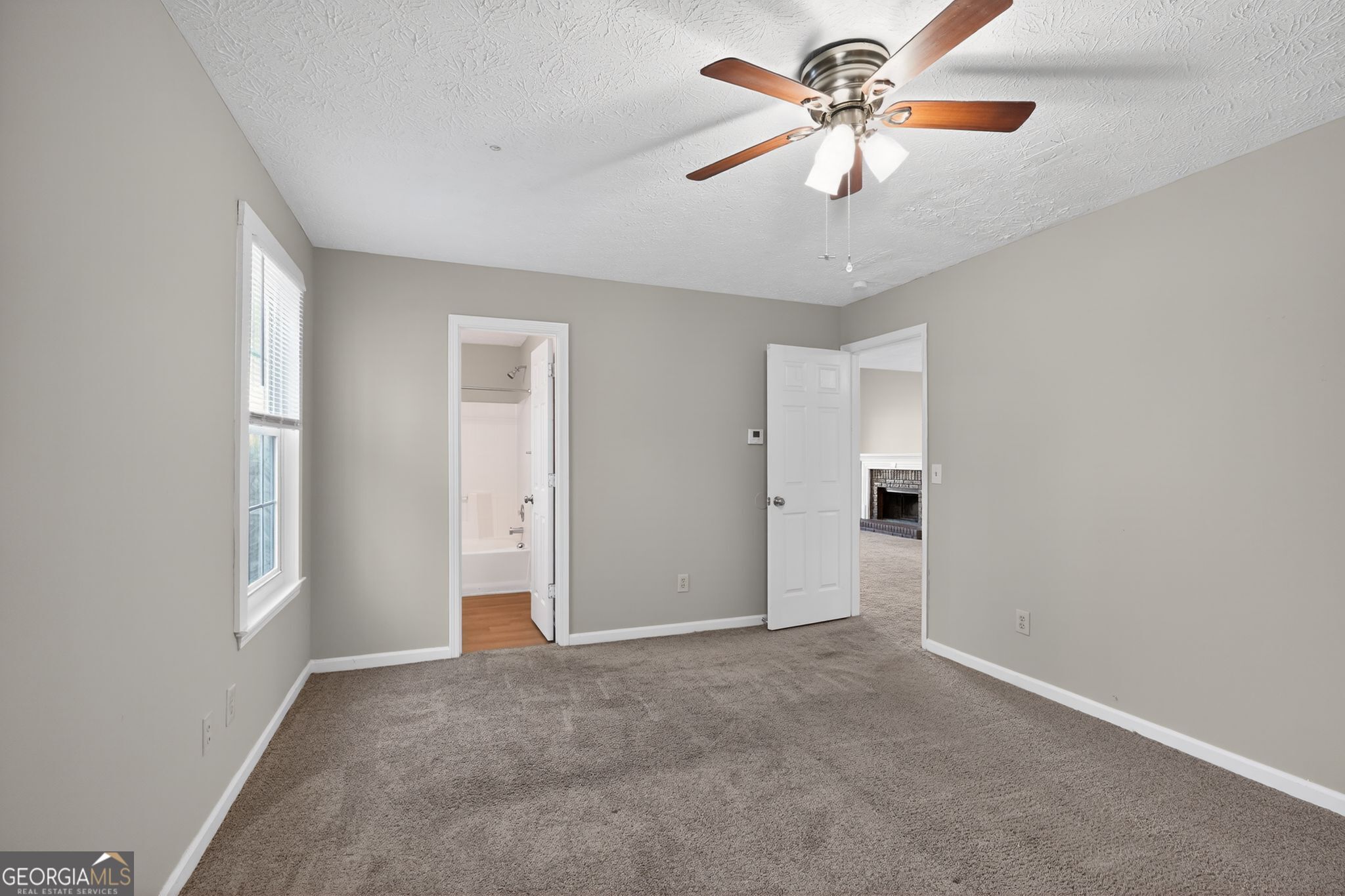 3751 Oakwood Manor Court Decatur, GA 30032 - Photo 25 of 33 a view of a room with a ceiling fan and a window