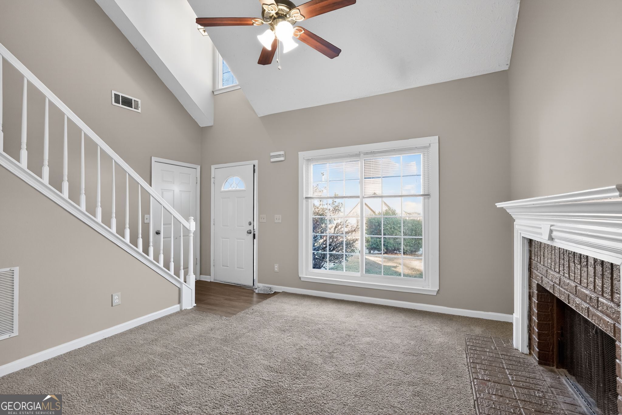 3751 Oakwood Manor Court Decatur, GA 30032 - Photo 5 of 33 a view of an empty room with chandelier fan and fire place