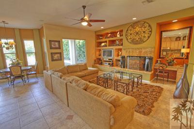 a living room with fireplace furniture and a large window