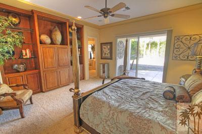 21 Bellisimo Court Rancho Mirage, CA 92270 - Photo 12 of 25 a bed sitting in a spacious bedroom next to a window