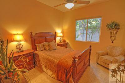 21 Bellisimo Court Rancho Mirage, CA 92270 - Photo 17 of 25 a bedroom with a bed and wooden floor