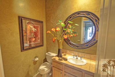 21 Bellisimo Court Rancho Mirage, CA 92270 - Photo 22 of 25 a bathroom with a toilet sink and mirror