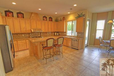21 Bellisimo Court Rancho Mirage, CA 92270 - Photo 4 of 25 a large kitchen with a large window and chairs