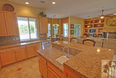 21 Bellisimo Court Rancho Mirage, CA 92270 - Photo 5 of 25 a large kitchen with kitchen island a large window cabinets a sink and stainless steel appliances