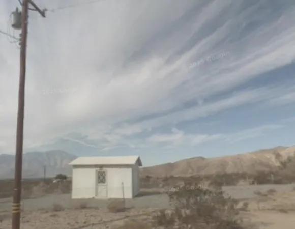 a view of a dry yard in front of a house