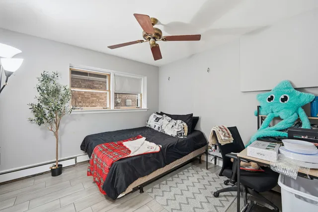 a view of a refrigerator in kitchen and an empty room