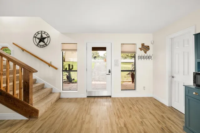 a view of an entryway with wooden floor
