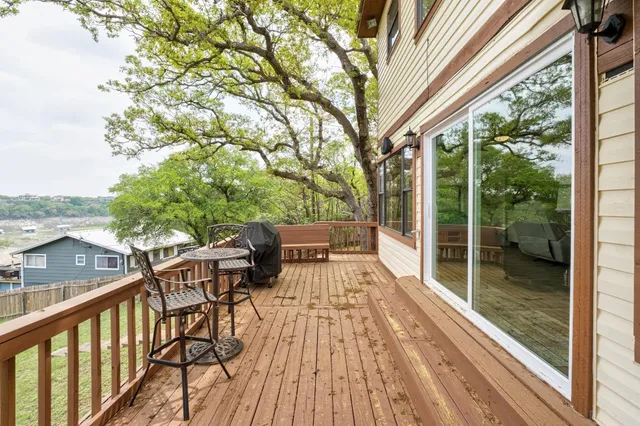 a view of balcony with chairs and wooden fence