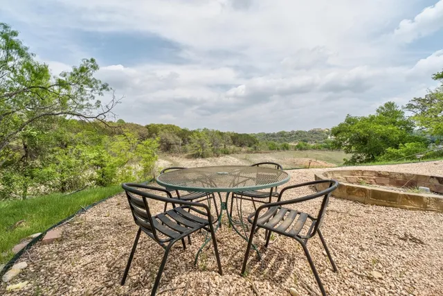 a view of a terrace with furniture and a garden