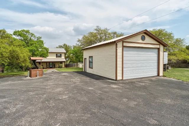 a view of a house with a yard and garage