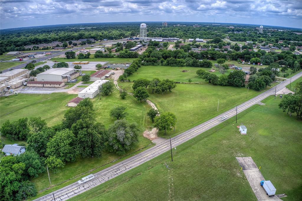 221 Maple Street Commerce, TX 75428 - Photo 6 of 19 a view of a city with lush green forest