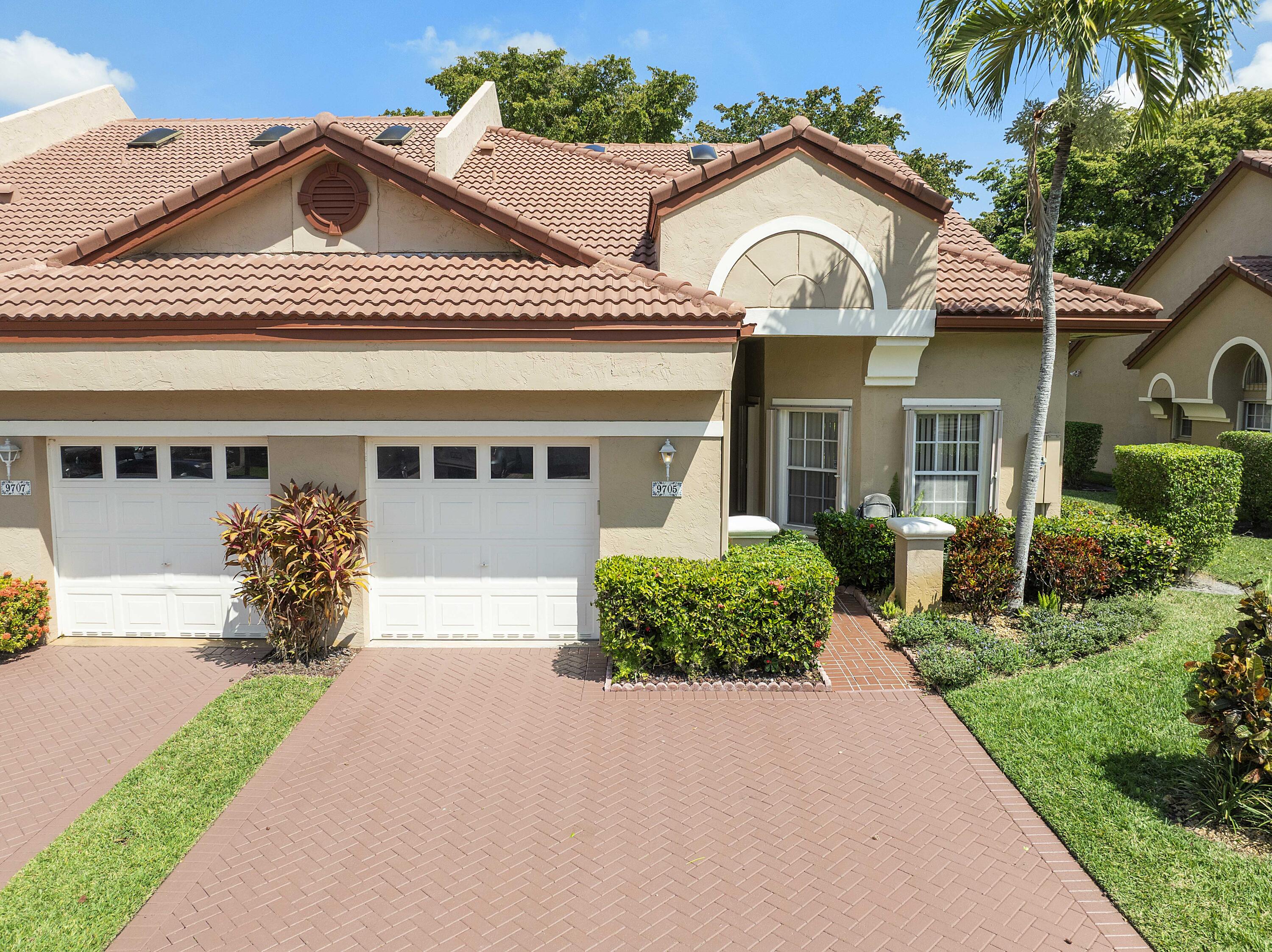 9705 Malvern Drive Tamarac, FL 33321 - Photo 1 of 29 a front view of a house with a garden and plants