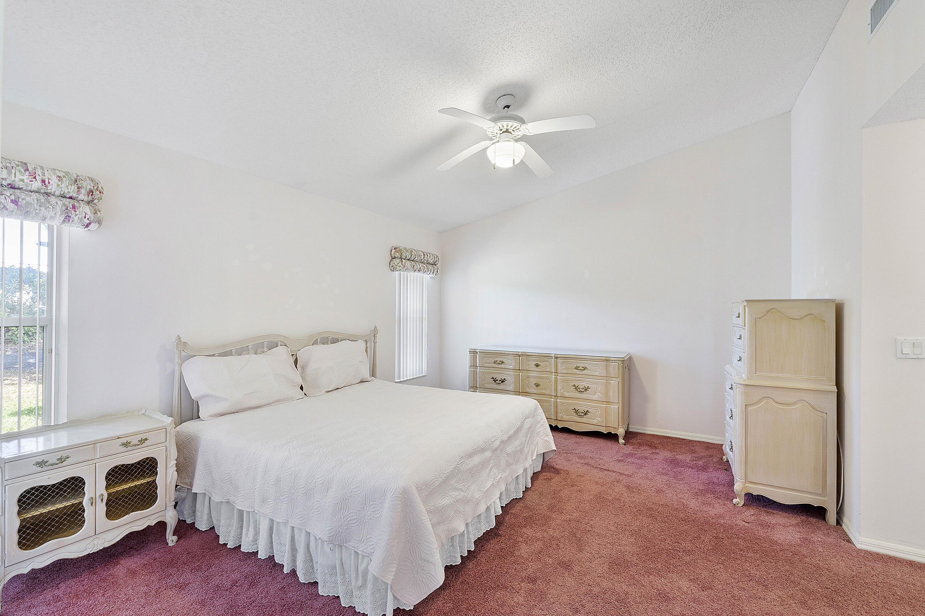 9705 Malvern Drive Tamarac, FL 33321 - Photo 14 of 29 a bedroom with a bed and a chandelier