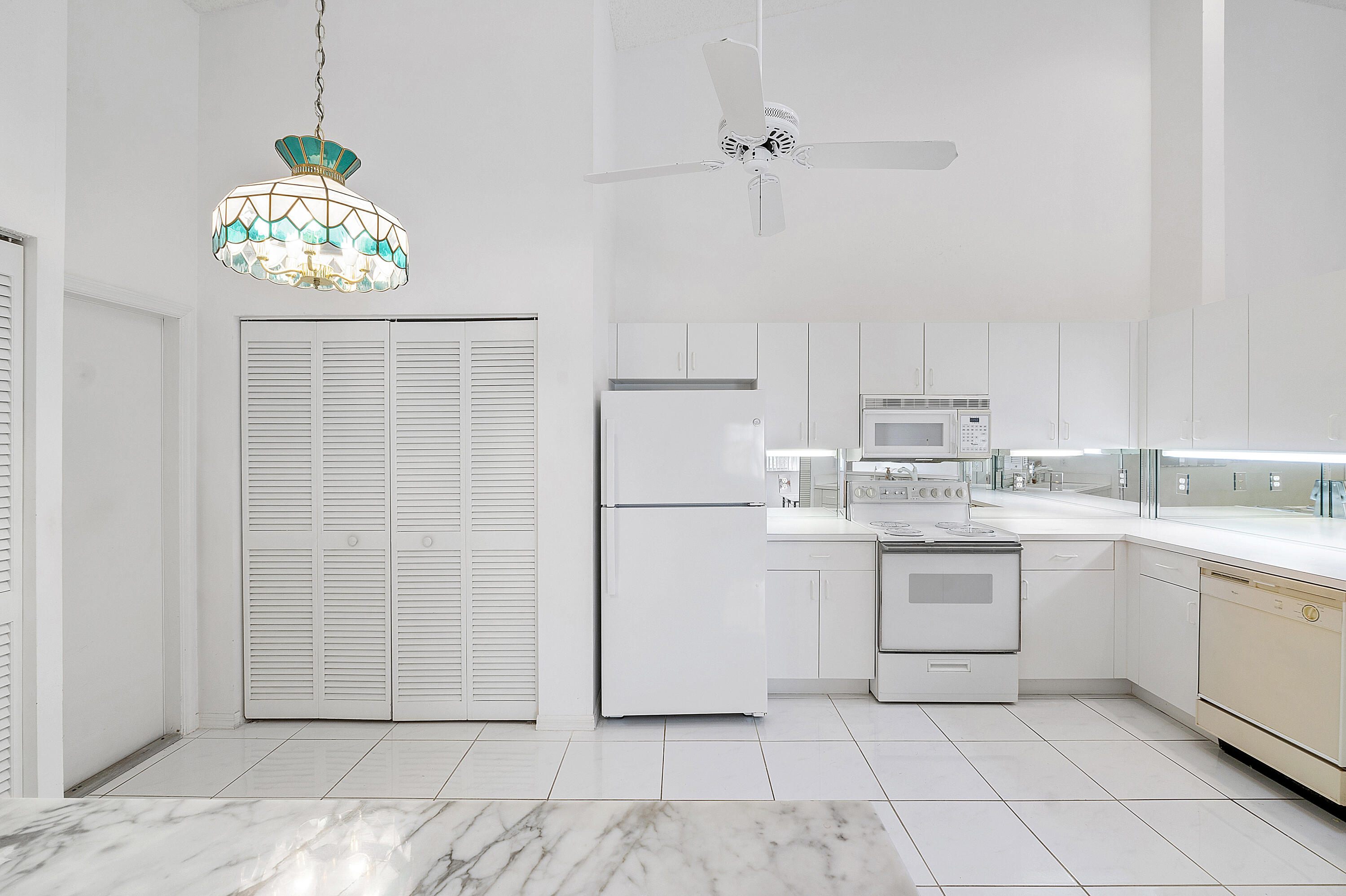 9705 Malvern Drive Tamarac, FL 33321 - Photo 8 of 29 a kitchen with white cabinets and white appliances