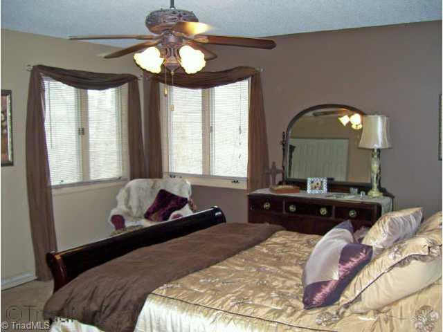 8528 Benbow-Merrill Road Oak Ridge, NC 27310 - Photo 6 of 9 Other. Lakeside master bedroom with corner windows and large closets.