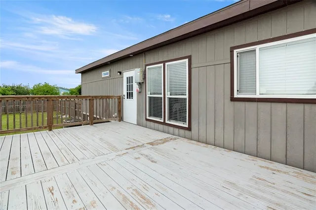a view of backyard with a deck