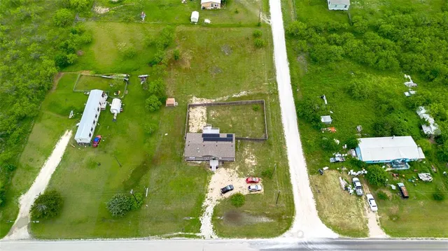 an aerial view of residential houses with outdoor space and swimming pool