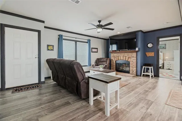 a living room with furniture a fireplace and a flat screen tv