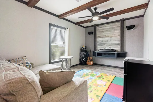 a bedroom with furniture and a large window
